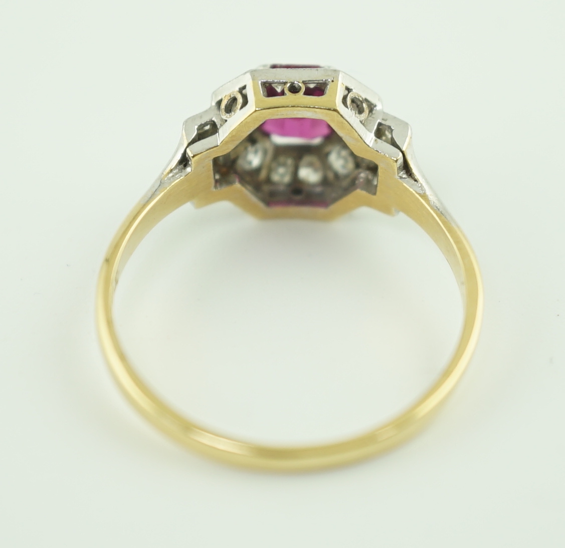 A 1950's Art Deco 18ct gold and platinum, ruby and millegrain set diamond octagonal cluster ring